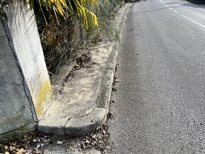 Photo 16 - Uneven sidewalk, continuation on the edge of the road