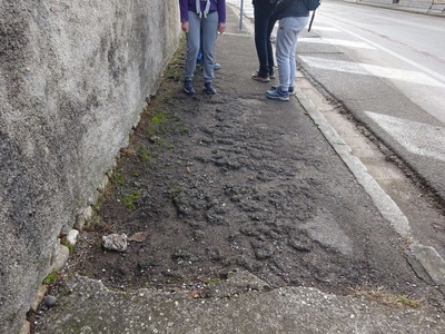 Photo 3 - Paved sidewalk with unevenness and potholes