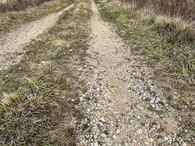 Photo 51 - Uneven road with dips and medium-sized stones